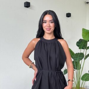 Nahaufnahme eines schwarzen Halter-Tops mit geraffelten Details, zarten Falten und dünnem Taillengürtel. - Großhandel Türkei