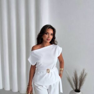 Weißes asymmetrisches Off-Shoulder-Blusen-Outfit mit Gürtel aus Goldringen und taillierten weißen Hosen, gestylt mit Gold-Clutch und Armreifen. - Türkei-Großhandel verfügbar