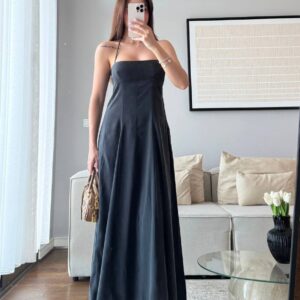 Floor-length black A-line maxi dress with fitted straight bodice, thin halter neck strap and flowing skirt. - available for wholesale in Turkey