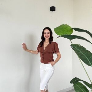 Brown tie-front V-neck blouse with puff sleeves, paired with white pencil skirt and pointed white heels.