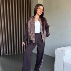Two-piece brown tracksuit with monogram panels on bomber jacket and side-stripe wide-leg pants.