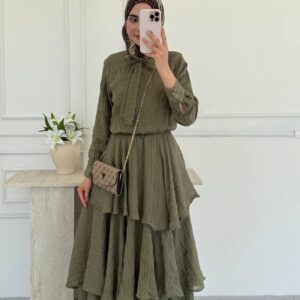 Full-length front shot of olive tiered maxi dress featuring multiple flounced tiers, belted waist and long sleeves. Wholesale Turkey.