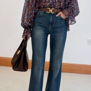 Front view of model in sheer brown blouse with blue polka dots tucked into high-waist wide-leg jeans with brown belt. available for wholesale in Turkey.
