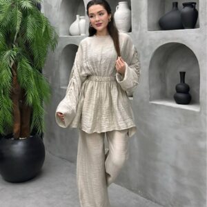 Vista frontal de conjunto beige texturizado de dos piezas con mangas globo, cintura elástica y pantalones anchos plisados. Disponible para mayorista en Turquía. - Mayorista Turquía