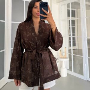 Front view of brown lightweight kimono with small botanical print, sash tied at waist and relaxed wide sleeves.