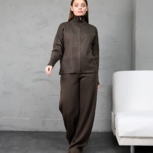 Front view of chocolate brown knitted zip cardigan with ribbed hem paired with relaxed wide-leg trousers.