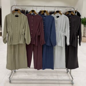 Full-length mirror image of pale grey flowy two-piece with front buttons and relaxed wide trousers.
