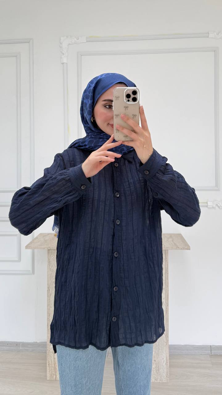 navy-crinkle-tunic-6881 Front view of navy crinkle-texture tunic with buttons and collar, shown with light jeans and a patterned blue headscarf.