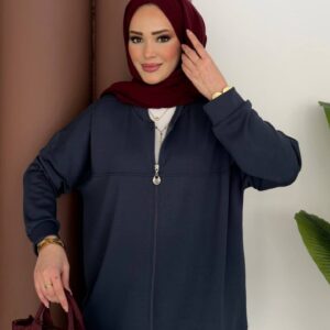 Model wearing navy zip-front tunic and wide-leg pants, maroon hijab and small maroon handbag. available for wholesale in Turkey.