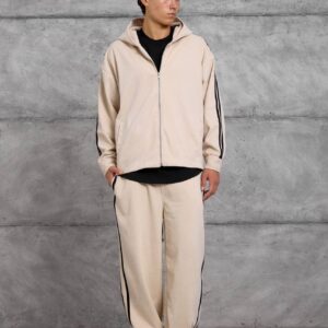 Full front view of a beige zip-up hoodie and loose trousers with black side stripes. available for wholesale in Turkey.