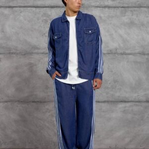 Full view of a blue denim jacket and loose trousers with pale side stripes. available for wholesale in Turkey.