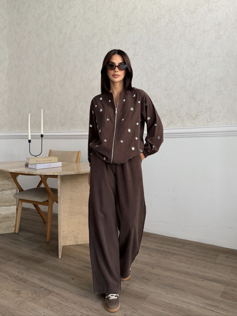 brown-embellished-set-fullview-4827 Full view of a brown zip-front jacket and wide-leg trousers with scattered silver embellishments available for wholesale in Turkey.