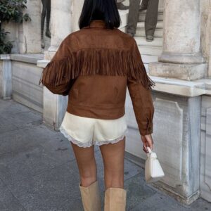Rear view of brown suede jacket with continuous fringe across the shoulders and a relaxed cropped fit.