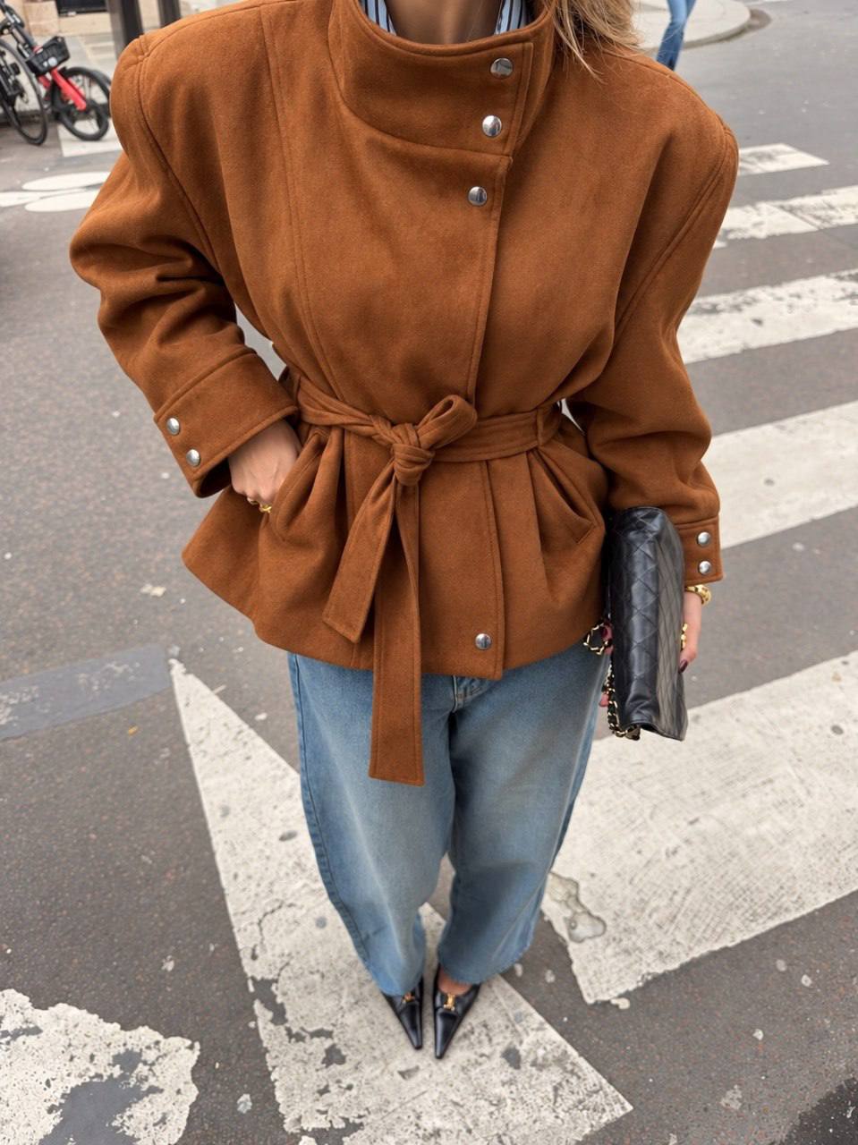 brown-jacket-button-detail-7391 Close view of a brown jacket with an asymmetrical button front, cuff buttons, and a tied belt.