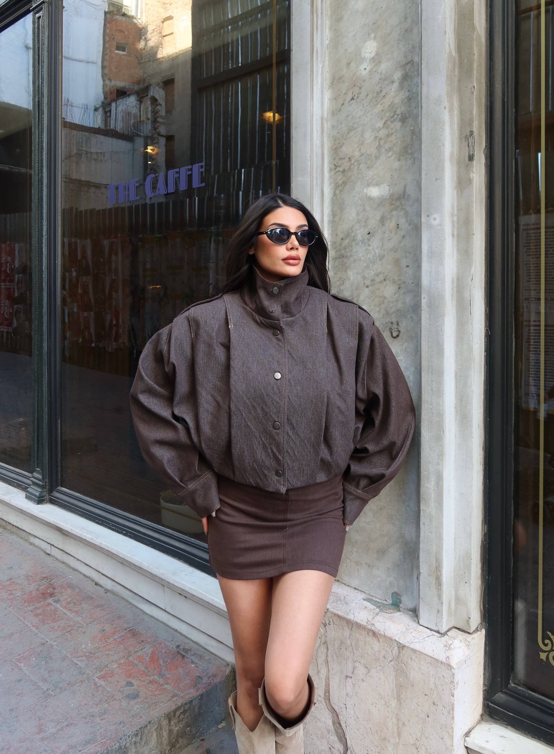 brown-jacket-skirt-look-4925 Model wears a brown snap-front jacket with wide sleeves and a matching fitted mini skirt.
