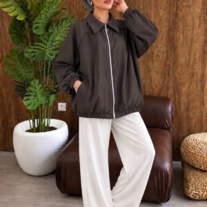 Model wears a charcoal collared jacket with a front zipper, elastic cuffs, and gathered hem.