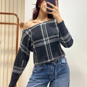 Charcoal fuzzy knit sweater with white plaid checks, long sleeves, a cropped hem, and an asymmetrical neckline.