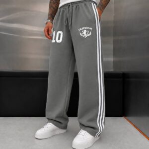 Front view of loose gray joggers with white side stripes, drawstring waist, and printed thigh graphics. available for wholesale in Turkey.
