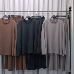 Three matching lounge sets on rack: brown, charcoal, and taupe long-sleeve tops with elastic-waist pants.