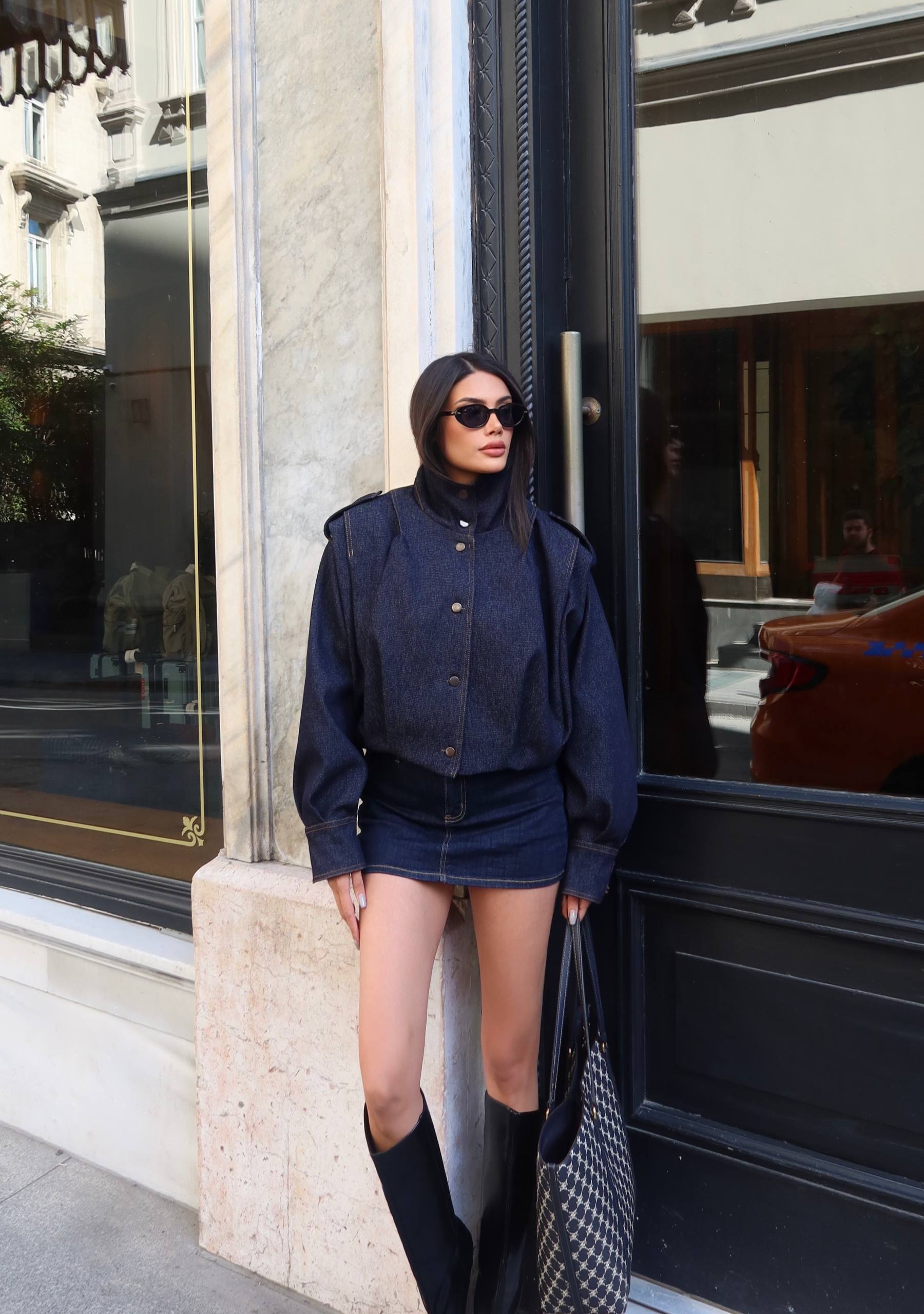 indigo-denim-outfit-full-9052 Model wears an indigo snap-front jacket with wide sleeves and a matching short denim skirt.