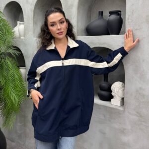 Front view of oversized navy zip jacket with cream horizontal stripe across chest and relaxed fit pockets