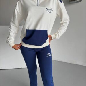 Close front view showing the navy pouch pocket, zip neckline, and matching navy pants.