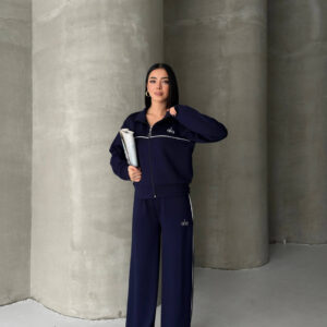 Full view of a navy zip-front jacket and matching wide-leg trousers with white piping. available for wholesale in Turkey.