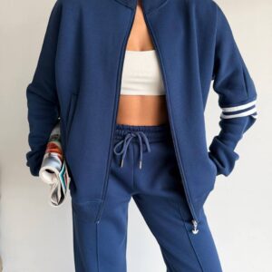 Close view of a navy zip jacket and drawstring pants with white sleeve stripes. available for wholesale in Turkey.