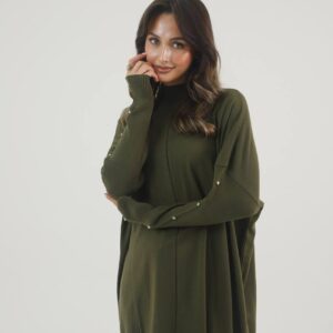 Three-quarter side view of olive high-neck knit tunic with ribbed sleeve panels and scattered rhinestone studs.