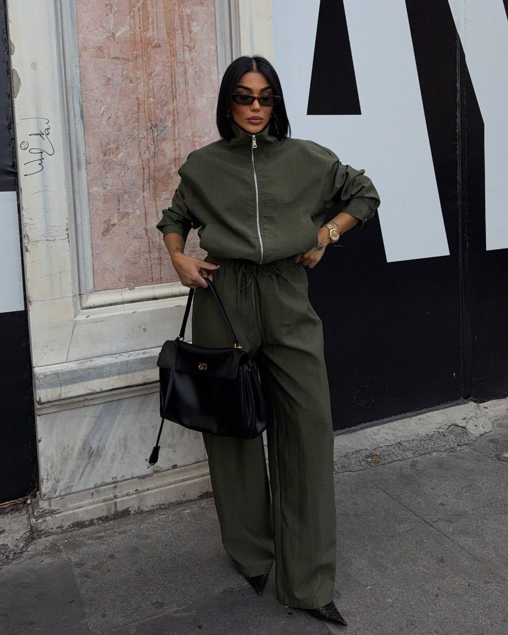 olive-tracksuit-full-length-7602 Full-length view of an olive zip-front jacket and matching trousers with a drawstring waist.