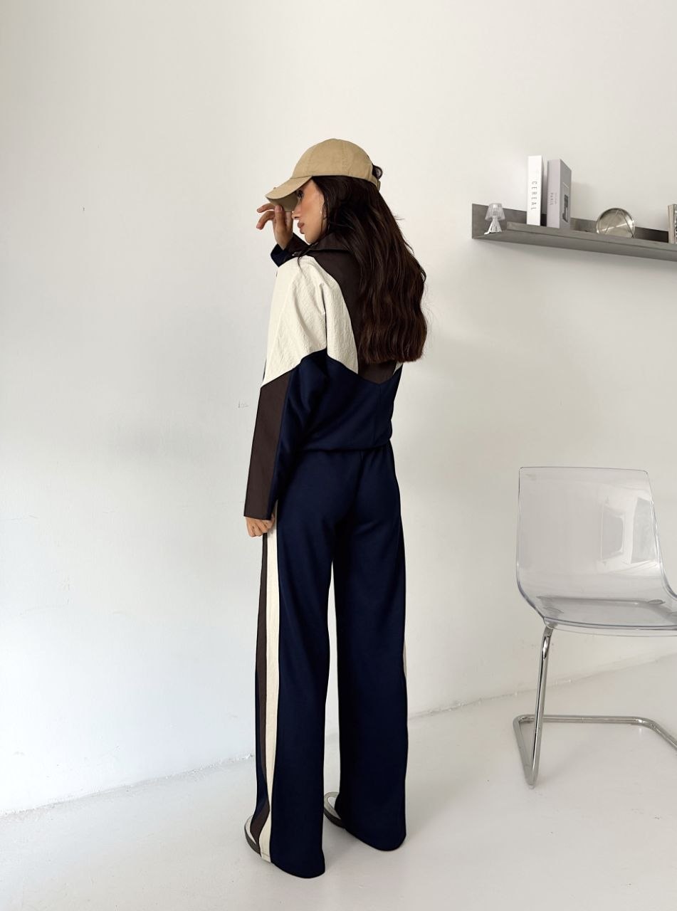 tracksuit-back-side-panels-4380 Rear view of the navy set showing a colorblocked jacket and cream and brown stripes along the pants.