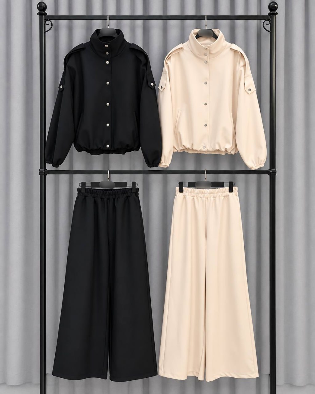 two-tone-set-display-9562 Cream and black outfit sets displayed on hangers, each with a button-front jacket and wide-leg trousers.