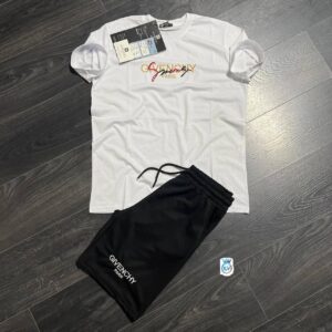 Flat lay of a white crew-neck tee with decorative chest lettering and black drawstring pants.
