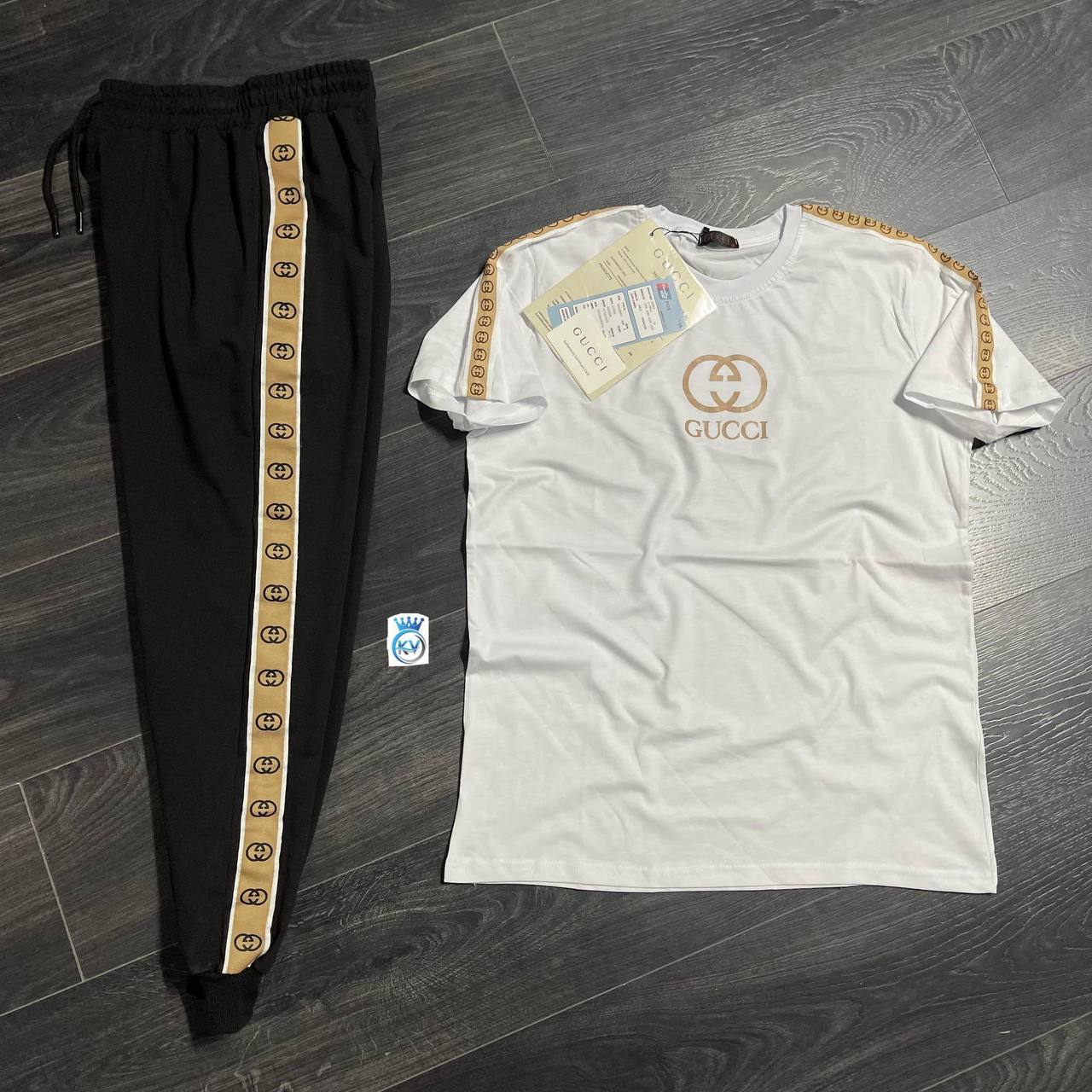 white-tee-black-track-pants-5837 White short-sleeve T-shirt with a circular chest emblem beside black track pants with tan logo-patterned stripes. available for wholesale in Turkey.