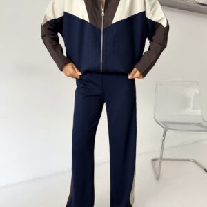 Front view of navy wide-leg pants with brown and cream side panels beneath a matching zip jacket.