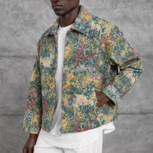 Angled view of a multicolor printed jacket with a pointed collar, front zipper, and side pockets.