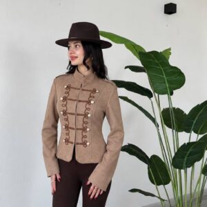 Three-quarter view of a beige fitted jacket with a stand collar, loop trim, and silver-tone buttons. available for wholesale in Turkey.