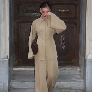 Model wearing a beige collared top with long sleeves and matching wide-leg trousers. available for wholesale in Turkey.