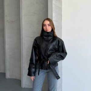 Black button-front faux-leather jacket with a raised collar, long sleeves, wide cuffs, and a loose tie belt.