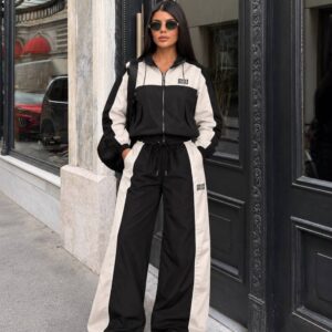 Full-length view of a black zip-up jacket and wide-leg trousers with cream panels. available for wholesale in Turkey.