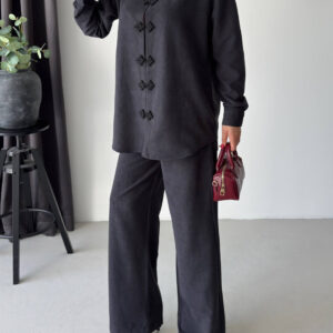 Black collared shirt with floral frog closures paired with matching wide-leg trousers.