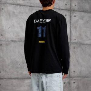 Rear view of a black long-sleeve shirt with lettering above a large blue number and a small yellow detail.