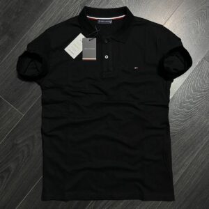 Front view of a black short-sleeve polo shirt with a button placket and small chest emblem. available for wholesale in Turkey.