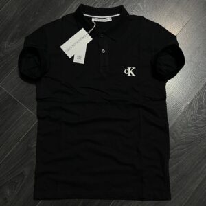 Black short-sleeve polo shirt featuring a button placket and small white chest emblem, laid flat.