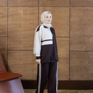 Full-length view of a black and cream zip jacket with matching wide-leg striped pants. available for wholesale in Turkey.