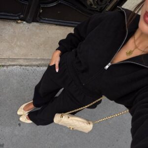 Angled view of a black zip-front sweatshirt and wide-leg trousers. available for wholesale in Turkey.