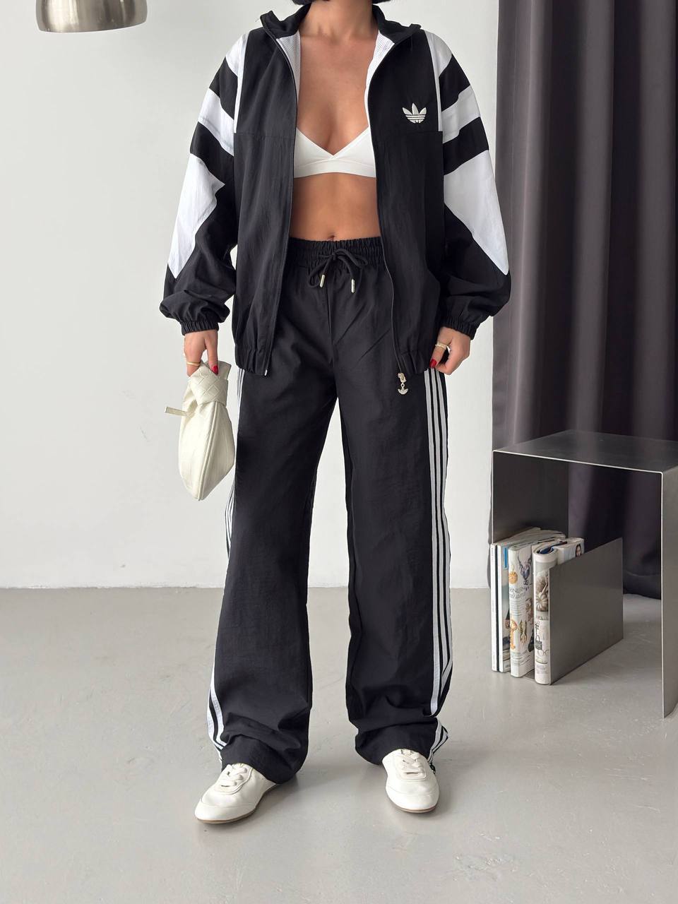 black-tracksuit-open-front-7269 Open black zip jacket with white geometric sleeve panels, paired with loose black trousers featuring white side stripes.