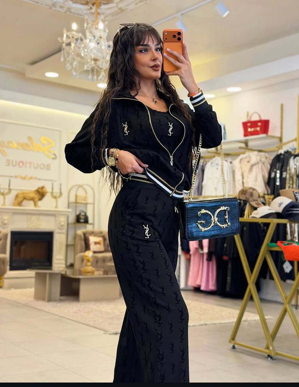 black-tracksuit-side-view-9143 Side view of a black matching set with a patterned jacket, striped cuffs, and relaxed trousers.
