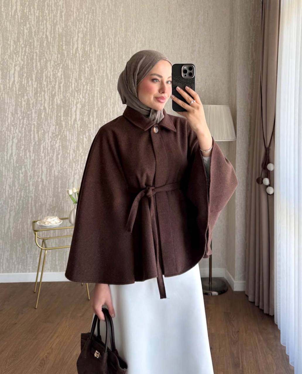 brown-belted-cape-coat-4837 Model wearing a brown cape-style coat with a pointed collar, single button, and matching waist tie. available for wholesale in Turkey.