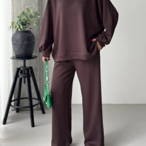 Brown crewneck sweatshirt with dropped shoulders and gathered cuffs paired with matching wide-leg trousers.